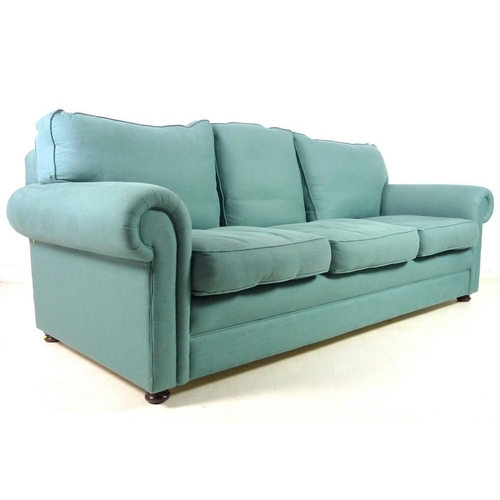 869A - A modern three seater Chesterfield style sofa, with loose feather cushions, flattened bun feet, upho... 