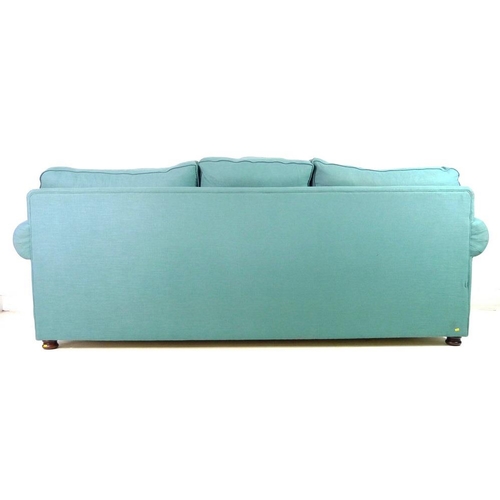 869A - A modern three seater Chesterfield style sofa, with loose feather cushions, flattened bun feet, upho... 