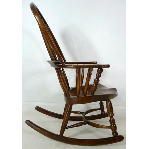 870A - A 19th century Windsor armchair, later amended with rocking base, high spindle back, shaped armrest ... 