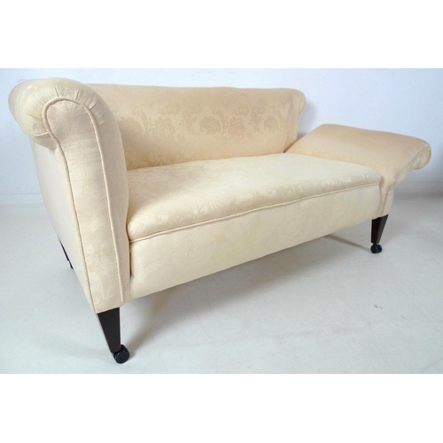 873 - An Edwardian drop end two seater settee, upholstered in cream foliate fabric, raised on square secti... 