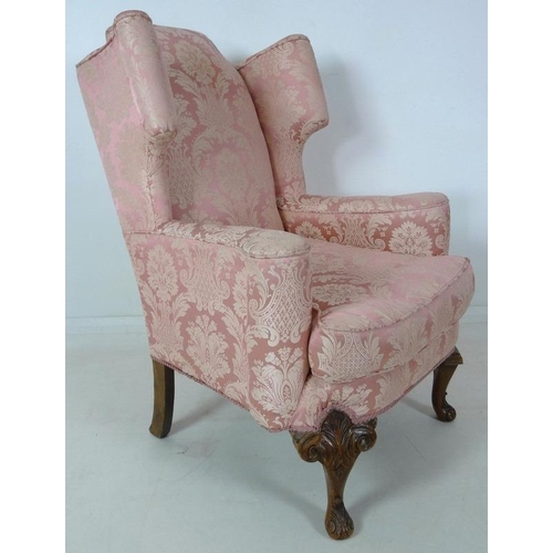 874 - A Queen Anne style wing back arm chair, early to mid 20th century, raised on carved cabriole front l... 