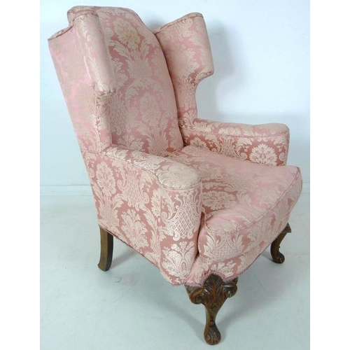 874 - A Queen Anne style wing back arm chair, early to mid 20th century, raised on carved cabriole front l... 