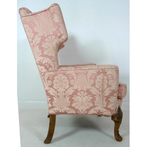 874 - A Queen Anne style wing back arm chair, early to mid 20th century, raised on carved cabriole front l... 