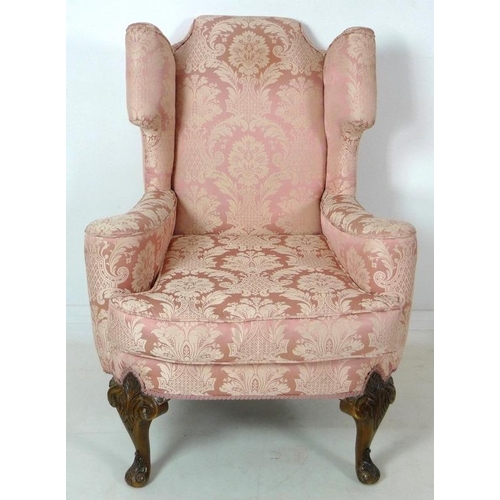 874 - A Queen Anne style wing back arm chair, early to mid 20th century, raised on carved cabriole front l... 