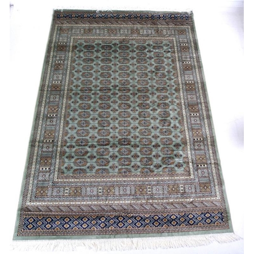 874A - A modern Bokhara rug with pale green ground and repeating gul decoration to the field, multiple bord... 