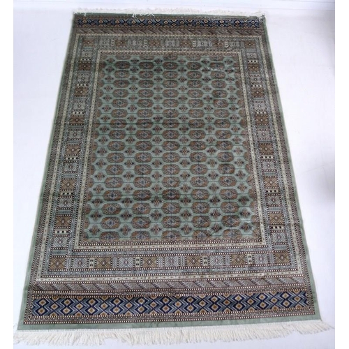 874A - A modern Bokhara rug with pale green ground and repeating gul decoration to the field, multiple bord... 