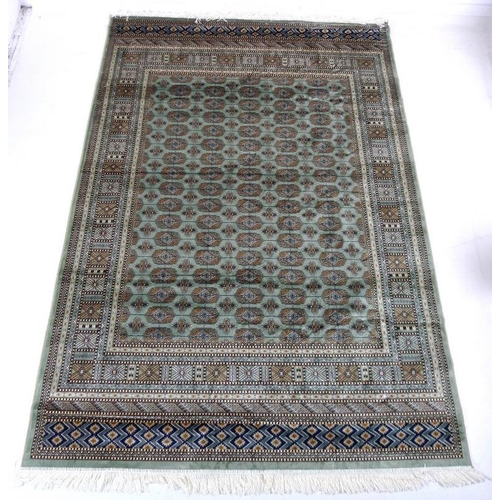 874A - A modern Bokhara rug with pale green ground and repeating gul decoration to the field, multiple bord... 