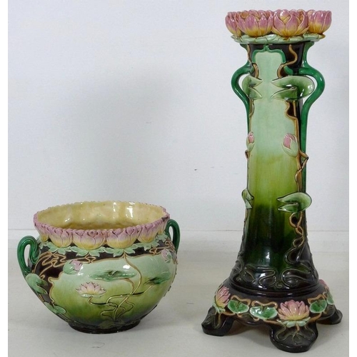 878 - An Austrian Art Nouveau ceramic jardiniere and stand, modelled overall with water lily flowers and l... 