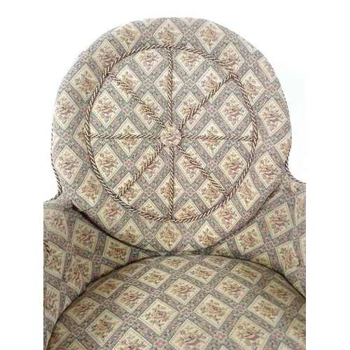 885 - A Victorian nursing chair, with shield shaped back, turned front legs and modern castors, upholstere... 