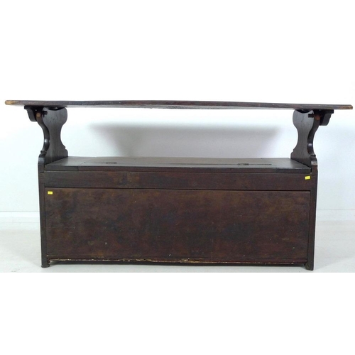 888 - A Victorian oak monk's bench, three panel front carved with floral and foliate motif, lift lid seat,... 