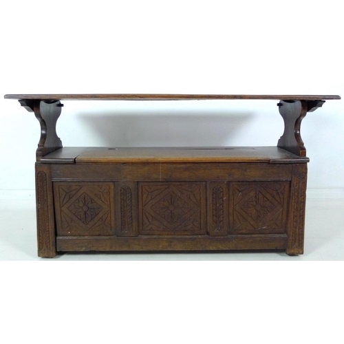 888 - A Victorian oak monk's bench, three panel front carved with floral and foliate motif, lift lid seat,... 