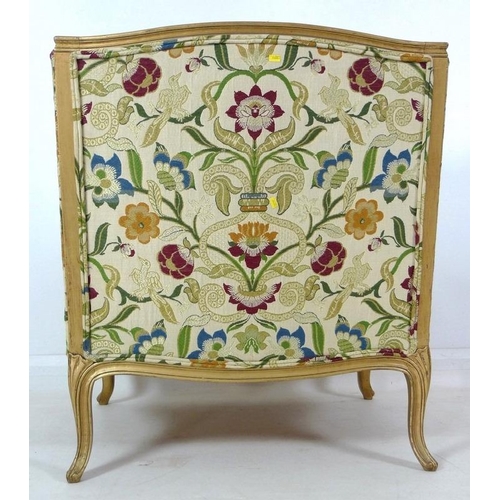 889 - A French carved wood wing armchair, in 19th century style, with gold coloured painted frame,  cream ... 