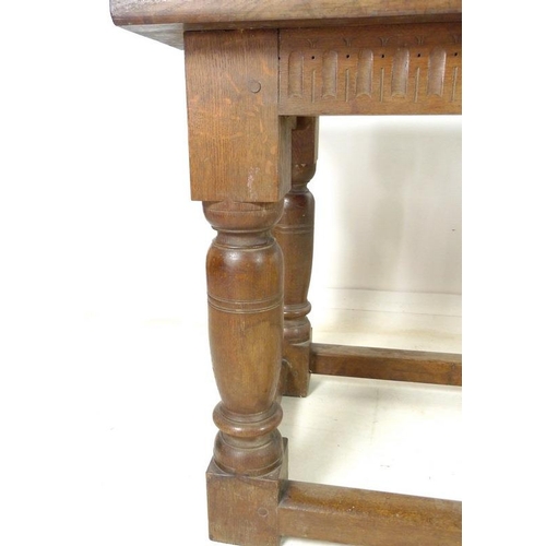 889A - An oak refectory table, three plank surface over a chip carved frieze, supported on heavy baluster t... 