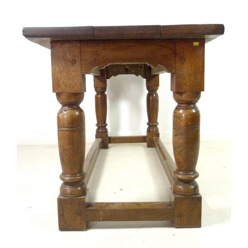 889A - An oak refectory table, three plank surface over a chip carved frieze, supported on heavy baluster t... 