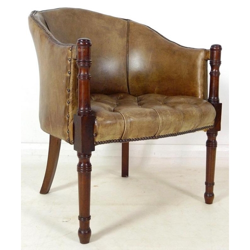 890 - A Georgian style green/beige leather library armchair, with buttoned seat and brass tacks, turned fr... 