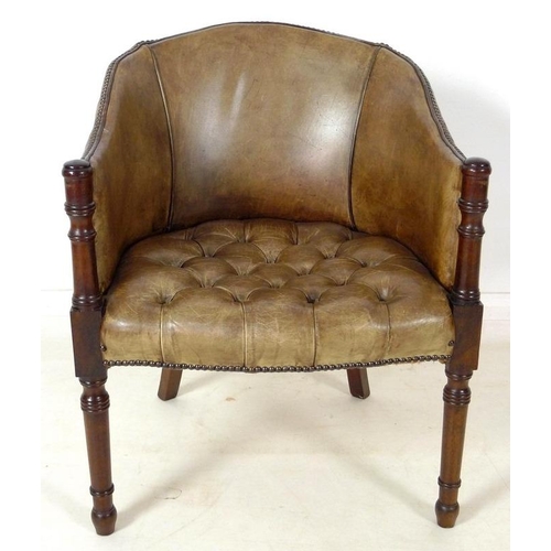 890 - A Georgian style green/beige leather library armchair, with buttoned seat and brass tacks, turned fr... 