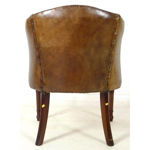 890 - A Georgian style green/beige leather library armchair, with buttoned seat and brass tacks, turned fr... 