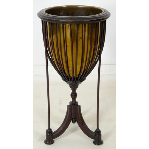 899 - An Edwardian mahogany plant stand, with spindle cage holding a brass lining, raised on three splay f... 