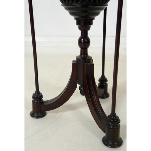 899 - An Edwardian mahogany plant stand, with spindle cage holding a brass lining, raised on three splay f... 