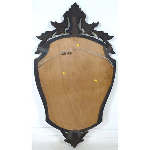 902 - A 1930's Venetian style glass mirror, of shield form with six shaped panels to the border, wheel eng... 