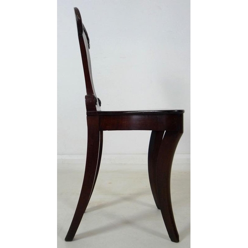 907 - A Regency mahogany hall chair, circa 1820, with gadrooned carving to the shield shaped back, raised ... 