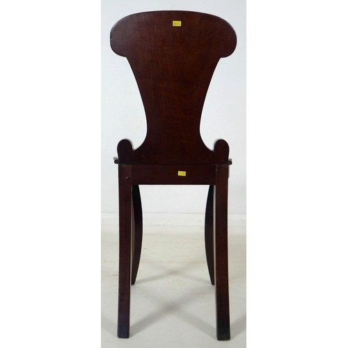 907 - A Regency mahogany hall chair, circa 1820, with gadrooned carving to the shield shaped back, raised ... 