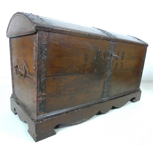 909 - An 18th century oak domed blanket chest with original intricate key, metal bound on a matched base, ... 