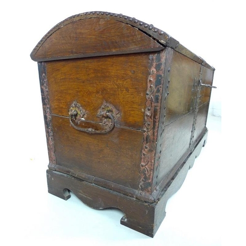 909 - An 18th century oak domed blanket chest with original intricate key, metal bound on a matched base, ... 