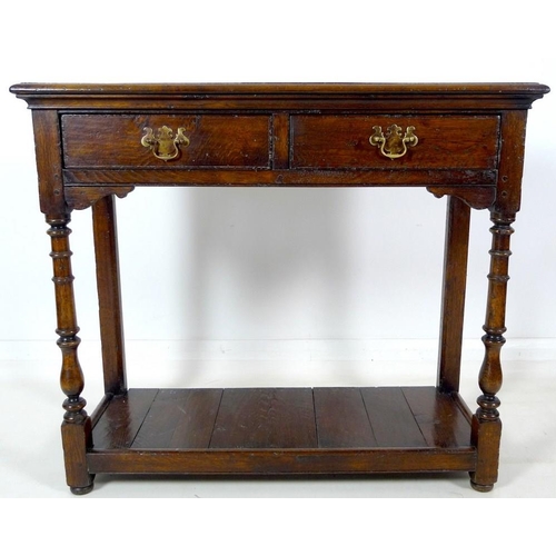 913 - A 19th century oak hall table, with two frieze drawers, brass plate swan neck handles, cock beading,... 