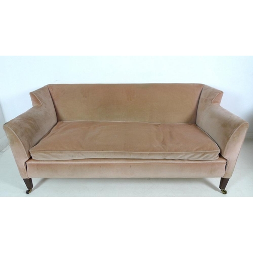 916 - An Edwardian two seater settee, with low wing back, upholstered in pale pink velvet, raised on taper... 