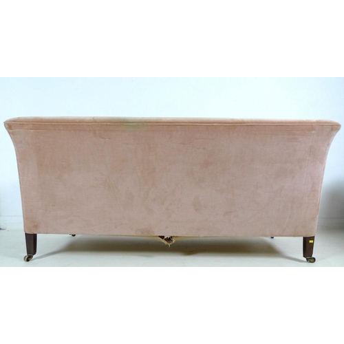 916 - An Edwardian two seater settee, with low wing back, upholstered in pale pink velvet, raised on taper... 