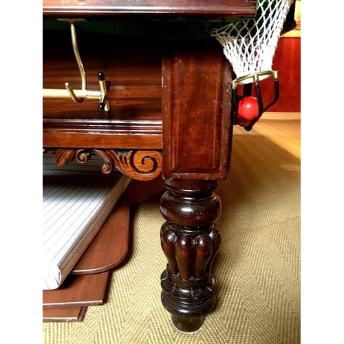 919 - A full sized slate bed billiards table in the William IV style, on mahogany lobed baluster legs, by ... 