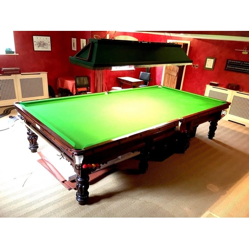 919 - A full sized slate bed billiards table in the William IV style, on mahogany lobed baluster legs, by ... 