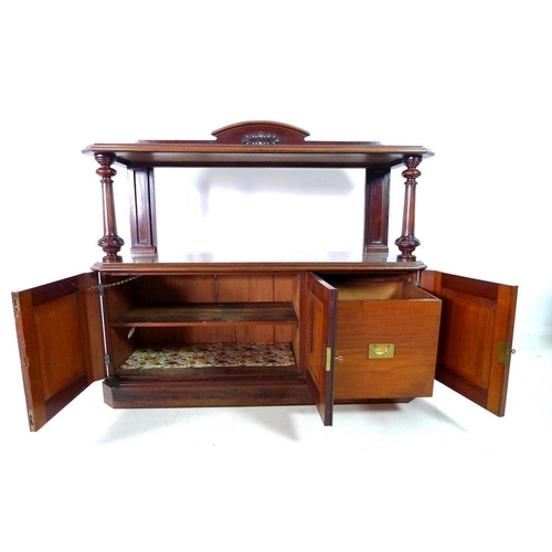 921 - An early Victorian mahogany buffet, with shaped upstand on an upper tier shelf, carved, turned and f... 