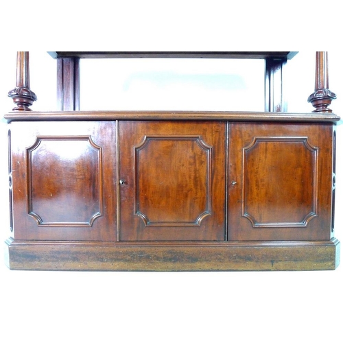 921 - An early Victorian mahogany buffet, with shaped upstand on an upper tier shelf, carved, turned and f... 