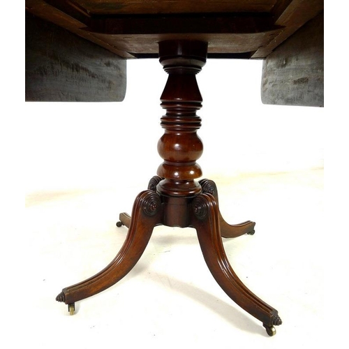 925 - A Regency mahogany sofa table, drop leaves, single drawer opposite false drawer with turned handle, ... 