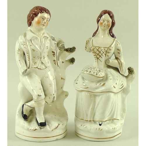 517 - Two late 18th / early 19th century Staffordshire figures of a man and a woman, arms a/f, together wi... 