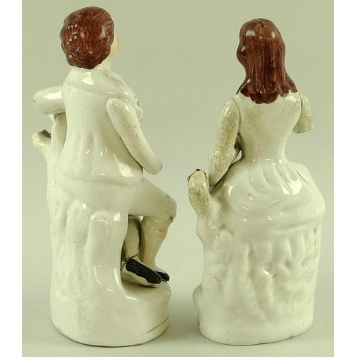 517 - Two late 18th / early 19th century Staffordshire figures of a man and a woman, arms a/f, together wi... 