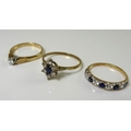 Three 9ct gold rings, one solitaire diamond set, 0.12ct, with leaf shoulders, size M, the second a d... 
