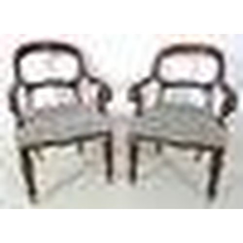 950 - A pair of 19th century open armed library chairs, by Gillows, shaped backs with scroll arms, the sea... 