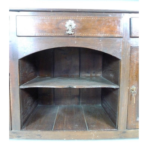 1001 - A Georgian oak and inlaid dresser, two shelf plate rack, the base with three frieze drawers, cast br... 