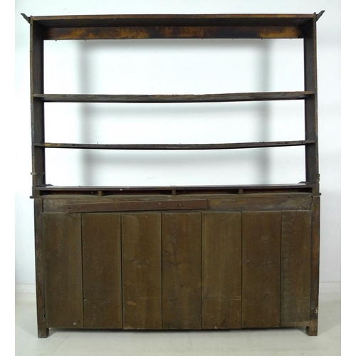 1001 - A Georgian oak and inlaid dresser, two shelf plate rack, the base with three frieze drawers, cast br... 