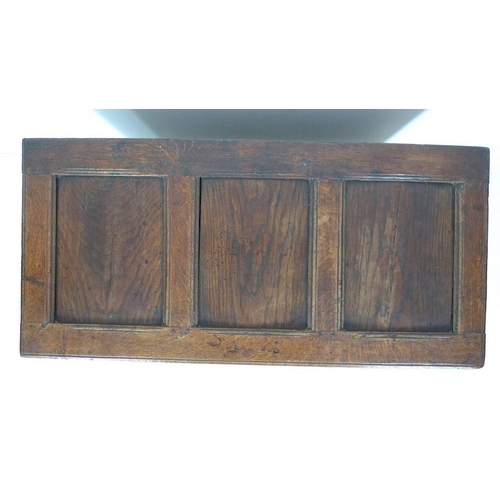 1006 - An 18th century oak coffer or blanket box, inlaid with chevron detailing, three arched panels to the... 