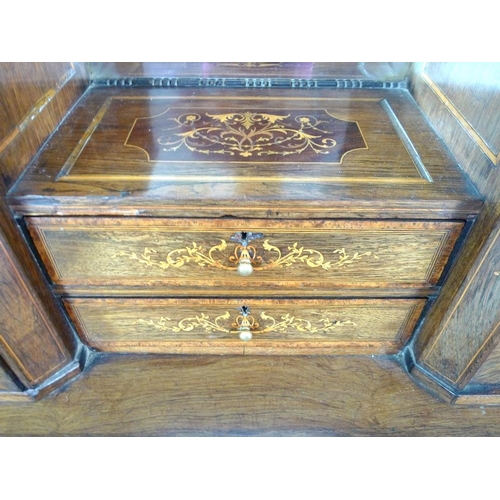 1007 - An Edwardian bonheur du jour, the top of mirror above two drawers, with cupboards either side above ... 