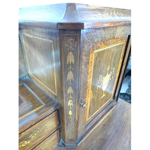 1007 - An Edwardian bonheur du jour, the top of mirror above two drawers, with cupboards either side above ... 