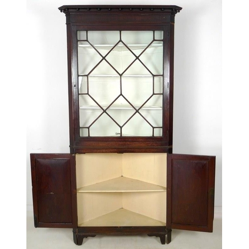 1012 - A George III mahogany corner cupboard, with astragal glazed single door above, enclosing three fixed... 