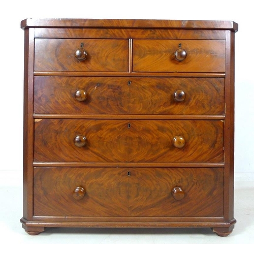 1017 - A Victorian flame mahogany veneered chest of two short over three long graduating drawers, with turn... 