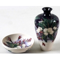 A Moorcroft ovoid vase, slim neck with flared rim, 16cm, together with a Moorcroft small shallow dis... 