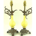 A pair of table lamp bases, 20th century, comprising bottle vases decorated in yellow glaze, mounted... 