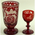 A Bohemian ruby engraved goblet decorated with opposing C scrolls with cross hatching, a house and a... 